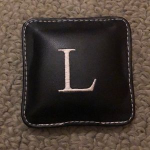 Leathery paperweight with L on it